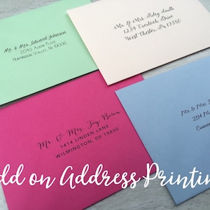 May include: Four rectangular envelopes in light green, cream, hot pink, and light blue, each featuring black printed addresses in a cursive script. The text Add on Address Printing is overlaid in white script at the bottom of the image.