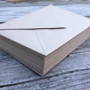 May include: A stack of plain brown envelopes, likely for mailing letters or invitations.