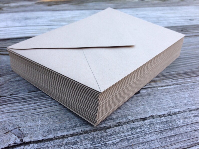 May include: A stack of plain brown envelopes, likely for mailing letters or invitations.