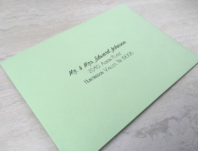 May include: A light green envelope with a black handwritten address that reads "Mr. & Mrs. Edward Johnson, 2040 Acorn Place, Huntingdon Valley, NY 19006"