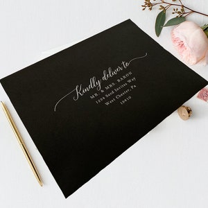 May include: Black envelope with white calligraphy that reads "Kindly deliver to MR. & MRS. BARON 1254 Seed Invites Way West Chester, Pa 19810"