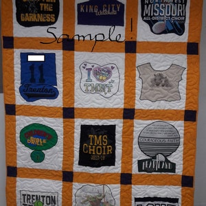 May include: A quilt made of various t-shirts with different designs and text. The quilt is orange, white, and black. The text on the shirts includes "Shatter the Darkness", "King City Wildkats", "Northwest Missouri All-District Choir", "Trenton", "I TMNT", "Children's Bible Drill", "TMS Choir 2017-18", "Courageous Faith Heartland Summer Camp", "Trenton Tennis", "LOVE", and "Michelangelo".