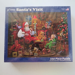 May include: A boxed 550-piece jigsaw puzzle titled "Santa's Visit." The image on the puzzle depicts Santa Claus seated with a child, a teddy bear, and a Christmas tree. The puzzle is made in the USA.