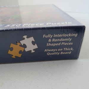 May include: A boxed 550-piece puzzle. The box is dark blue with white text that reads "Fully Interlocking & Randomly Shaped Pieces Always on Thick, Quality Board." Two puzzle pieces are shown in gold and white.
