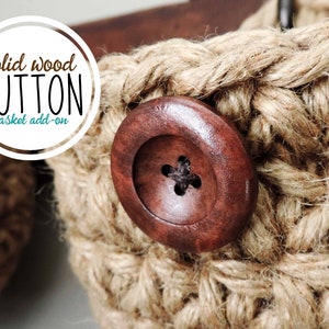 May include: A close-up of a brown wooden button with a black center. The button is attached to a woven jute basket.
