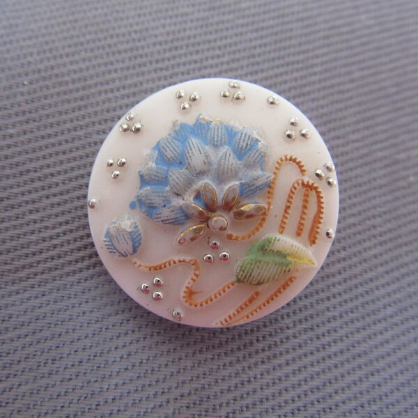 Medium vintage glass sewing button - impressed design of blue flower - early 20th century