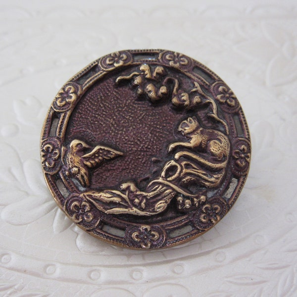 Large antique sewing button - brass - cat and bird - floral cut out border - very neat scene!