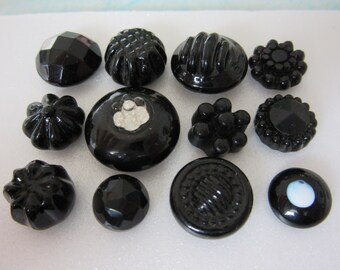 Lot of 12 small black glass sewing buttons - charmstring types - one coronet - swirl backs - collectibles, jewelry components...