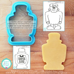 May include: A blue plastic cookie cutter shaped like a glass bottle with a label that reads "Vampire Blood". The cutter is on a wooden surface with a cookie that has been cut out using the cutter. The image also includes a sketch of the cutter and a copyright notice.