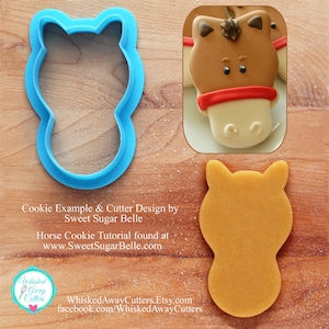 May include: A blue plastic cookie cutter shaped like a horse head. A brown sugar cookie cut with the cutter is shown next to it. The text "Cookie Example & Cutter Design by Sweet Sugar Belle" is below the cutter.