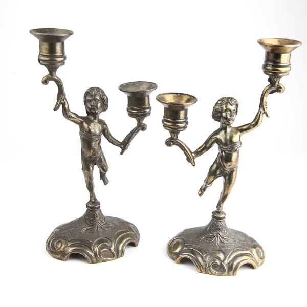 Pair of pre 1940 zamac candle holders, "angels", putti or taper