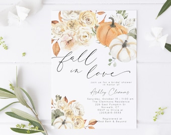 May include: A white invitation card with the words "fall in love" in elegant script. The card features watercolor illustrations of pumpkins and floral arrangements in shades of orange, cream, and green. Text details a bridal shower.