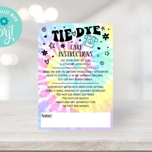 May include: A tie-dye care instructions card with a colorful background of pink, yellow, and blue. The card includes instructions on how to wash a tie-dye shirt, with the text "TIE DYE CARE INSTRUCTIONS" at the top. The card also has a space to write a name.