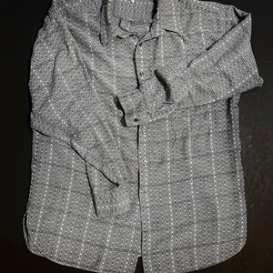May include: A gray and white checkered long-sleeved button-up shirt.