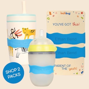 May include: A white cup with a straw and animal illustrations, a translucent bottle with a yellow lid, and two blue silicone bands labeled Ethan Bend. A rectangular card features the text inchbug, YOU'VE GOT this!, and PARENT OF THE year!.