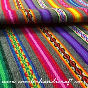 May include: Colorful striped fabric with a repeating pattern of geometric shapes. The fabric is woven with a variety of colors, including red, orange, yellow, green, blue, purple, and white. The fabric is folded in half, and the website address "www.condorhandicraft.com" is visible in the lower right corner.