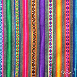 May include: Colorful striped fabric with a repeating pattern of geometric shapes. The fabric is woven with a variety of colors, including blue, green, red, orange, yellow, and purple. The fabric is made in Peru.