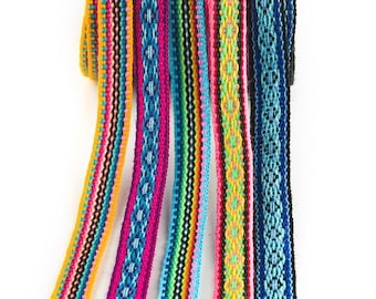 May include: Assortment of colorful woven ribbon trim with geometric patterns in shades of yellow, blue, pink, green, and black.