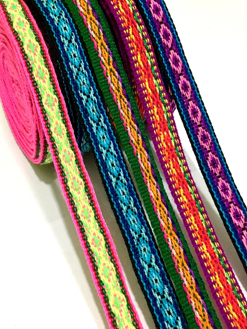 May include: Assortment of colorful woven ribbon trim with geometric patterns in pink, green, blue, purple, orange, and yellow.