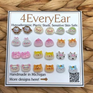 May include: A display card titled 4EveryEar featuring twenty-four hypoallergenic plastic stud earrings in various animal shapes and colors. The card includes the text Hypoallergenic Plastic Studs. Sensitive Skin Safe. Handmade in Michigan. More designs here!