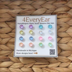 May include: A set of 12 colorful, hypoallergenic plastic stud earrings in various pastel colors, arranged on a white card. The card reads "4EveryEar" and "Handmade in Michigan."