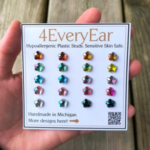May include: A card displaying a set of 16 star-shaped stud earrings in various colors. The card reads "4EveryEar" and "Hypoallergenic Plastic Studs. Sensitive Skin Safe." The text "Handmade in Michigan" is also visible.