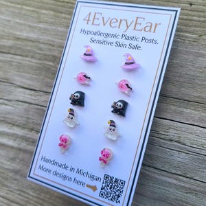 May include: A card displaying several pairs of Halloween-themed earrings. The earrings feature designs like witch hats, ghosts, and skulls. The card reads "4EveryEar" and "Handmade in Michigan".