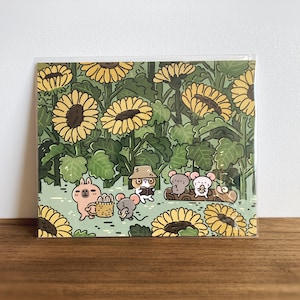 Impresión artística acogedora de Noristudio: lindo capibara y conejillo de indias en un campo de girasoles