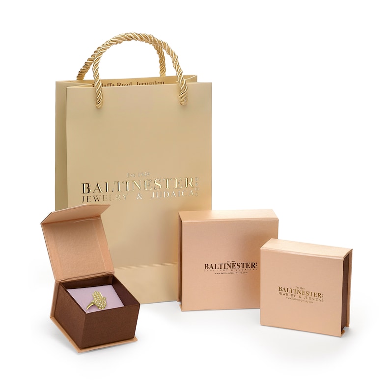 May include: A set of three boxes for jewelry and Judaica. The boxes are all beige with gold lettering. The largest box is a shopping bag with a gold rope handle. The smaller boxes are square and rectangular. The text on the boxes reads "Balitnester: Jewelry & Judaica".