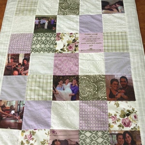 May include: A patchwork quilt featuring a variety of floral and patterned fabrics. The quilt includes photos of different people and families. The quilt has a light purple, white and green colour scheme. The quilt has a text panel that reads "Grandma's love is a journey made of memories, moments we treasure and memories we hold dear."