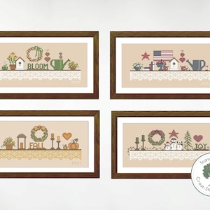 May include: Four framed cross-stitch patterns featuring seasonal themes. The top left pattern is a spring scene with a birdhouse, flowers, and a watering can. The top right pattern is a patriotic theme with a birdhouse, an American flag, and a watering can. The bottom left pattern is a fall scene with a lantern, pumpkins, and a wreath. The bottom right pattern is a winter scene with a snowman, a Christmas tree, and a wreath.