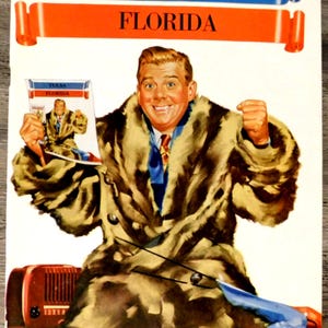May include: Vintage program cover featuring a man in a fur coat, holding a smaller version of the cover. The cover has the text "TULSA FLORIDA" in blue and orange banners. The program is dated October 1, 194.