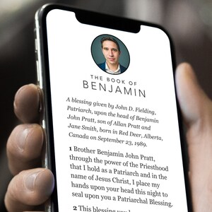 May include: A close-up of a smartphone screen displaying a document titled "The Book of Benjamin". The document contains a blessing given by John D. Fielding, Patriarch, upon the head of Benjamin John Pratt, son of Allan Pratt and Jane Smith, born in Red Deer, Alberta, Canada on 23 September 1989.