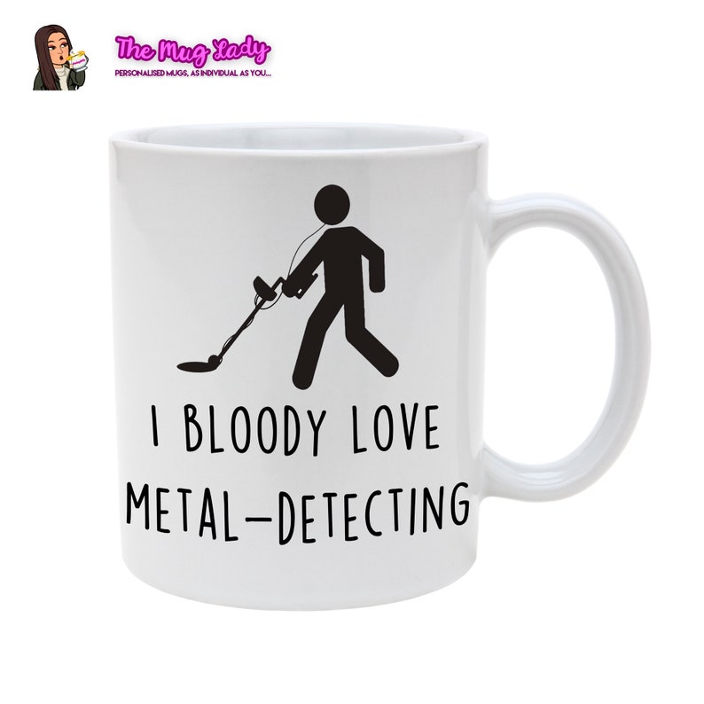 May include: White ceramic mug with a black silhouette of a person metal detecting. The text "I BLOODY LOVE METAL-DETECTING" is printed on the mug.