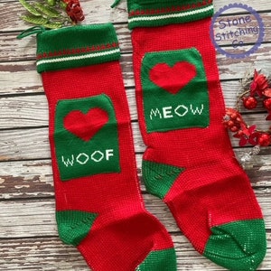 May include: Two red and green knitted Christmas stockings with a heart and the words "WOOF" and "MEOW" on them.