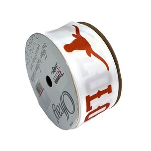 May include: White satin ribbon with an orange Longhorn steer head and the word "Hook 'em" printed on it. The ribbon is rolled up on a spool.
