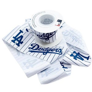 May include: A roll of white ribbon with a baseball jersey design featuring the Los Angeles Dodgers logo and team name in blue. The ribbon has vertical pinstripes and the team's "LA" logo.