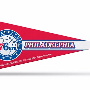 May include: A red, white, and blue pennant with the Philadelphia 76ers logo and the text "PHILADELPHIA" in blue lettering. The text "RICO INDUSTRIES, INC./© 2016 NBA Properties, Inc." is printed in black at the bottom.