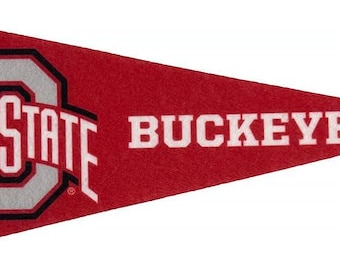 May include: A red pennant with the words "OHIO STATE BUCKEYES" in white. The Ohio State logo is in the center, with a gray "O" and a black outline. A black stripe runs along the left edge of the pennant.