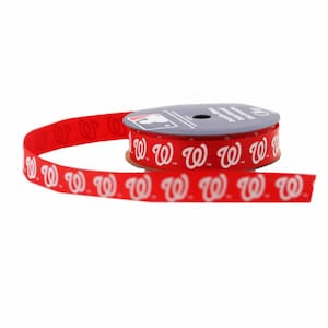 May include: A roll of red ribbon with white "W" logos printed on it. The ribbon is on a spool with a blue and white background.