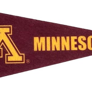 May include: Maroon pennant with gold trim and lettering. The pennant features a large gold "M" logo on the left and the word "MINNESOTA" in gold on the right. The pennant is triangular in shape.