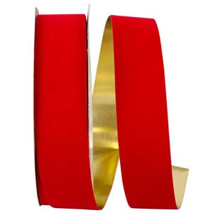 May include: A roll of ribbon featuring a vibrant red velvet texture on the front side and a smooth, reflective metallic gold finish on the reverse side. The ribbon is coiled in a loose, flowing shape, showcasing both the red and gold surfaces.