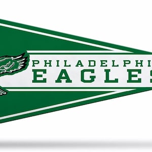 May include: A triangular green and white felt pennant featuring the Philadelphia Eagles logo, which depicts an eagle in flight clutching a brown football, with the text PHILADELPHIA EAGLES printed in bold green capital letters on a white stripe.