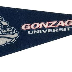 May include: Navy blue felt pennant with the Gonzaga University logo. The logo features a bulldog head in white and grey, encircled by a red ring. The words "GONZAGA UNIVERSITY" are printed in white and red.