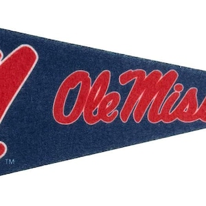 May include: A navy blue pennant with a red vertical stripe on the left side. The pennant features a large red letter "M" and the words "Ole Miss" in red script. The pennant is triangular in shape.