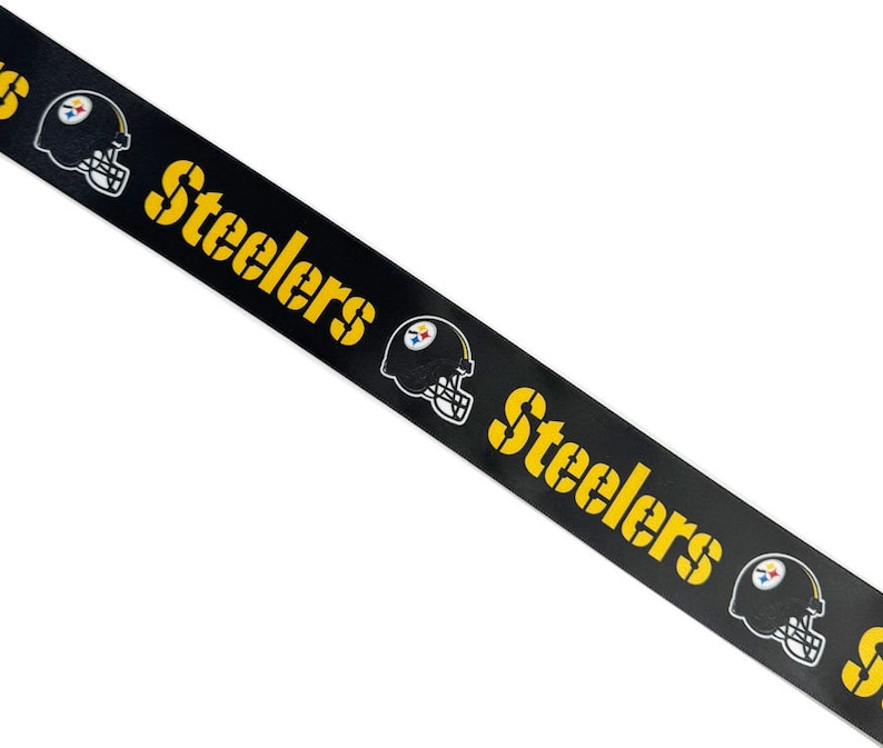 May include: Black and yellow ribbon with the word "Steelers" repeated and a football helmet graphic.