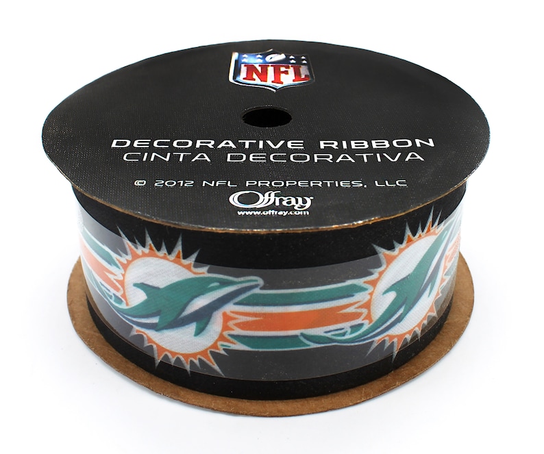 May include: A roll of black and teal decorative ribbon with a Miami Dolphins logo and the text "DECORATIVE RIBBON CINTA DECORATIVA &copy; 2012 NFL PROPERTIES, LLC Offray www.offray.com"