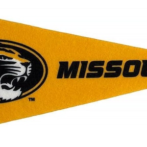 May include: A yellow pennant with a black vertical stripe on the left. The pennant displays the word "MISSOURI" in black, and a black and gold tiger logo inside an oval.