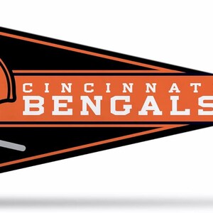 May include: A triangular felt pennant featuring a black background with an orange border. It displays an orange football helmet with the word BENGALS in black, and the text CINCINNATI BENGALS in white block letters on an orange horizontal stripe.