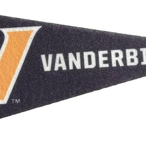 May include: A navy blue pennant with a gold and white "V" logo and the word "VANDERBILT" in white text. The pennant is triangular in shape and made of felt.